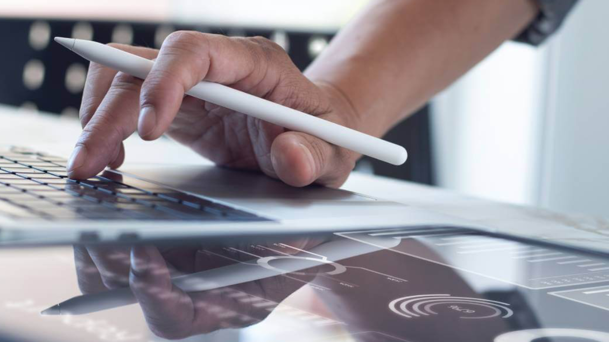 Man holding a pen on an ipad